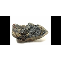 Матрикс, усеянный десятками мелких кристаллов ульманита серого цвета с металличесим блеском