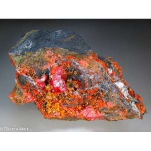 Вишнево-красный реальгар, крупный кристалл до 3 см с множеством желтых кристаллов аурипигмента до 2-4 мм