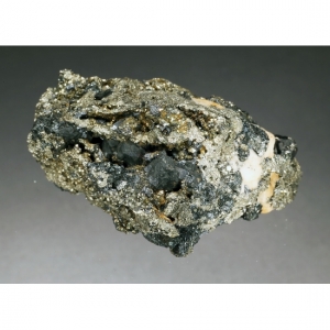 Черные, тусклые, сросшиеся кристаллы станнина до 0,8 см в матриксе. Оруро, Боливия
